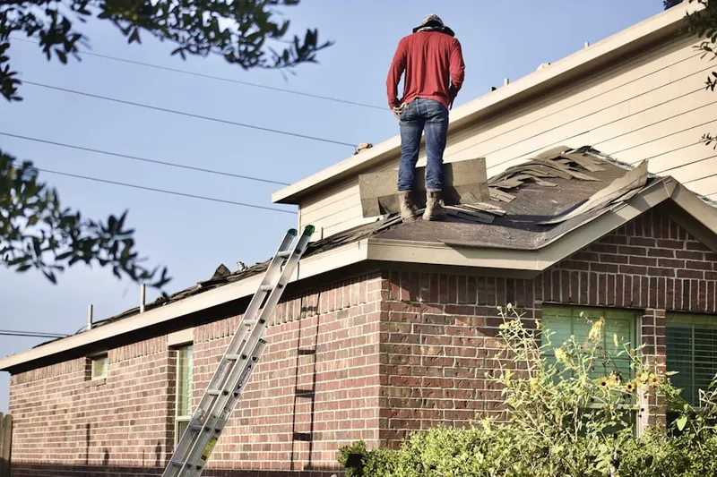 Professional roofer working on a residential roof in Dodson